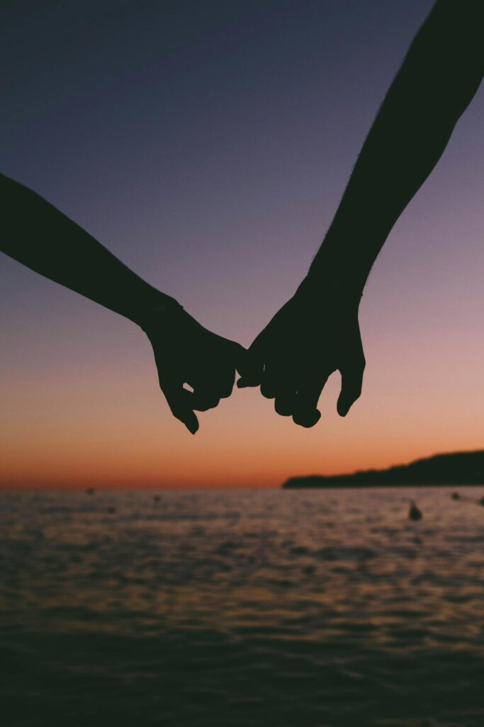 Two Person Holding Pinkies
