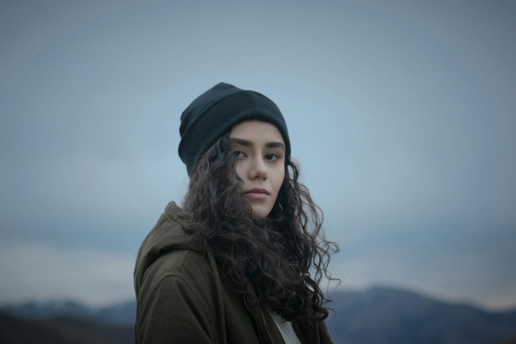 a woman with long hair wearing a beanie
