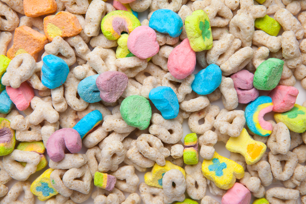 Frosted toasted oat cereal with fun shaped marshmallows on white background.

