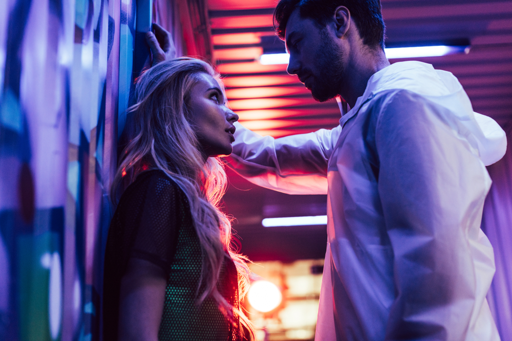 side view of attractive and blonde woman talking with man