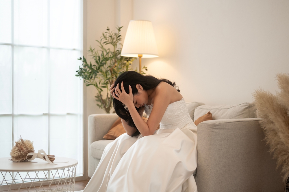 Sad and worried bride crying and arguing with groom in wedding day
