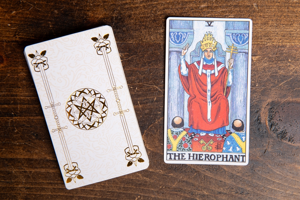 London, UK: 4 January, 2024: The 5 Major Arcana - The Hierophant Tarot Card of Rider Waite deck on wooden background