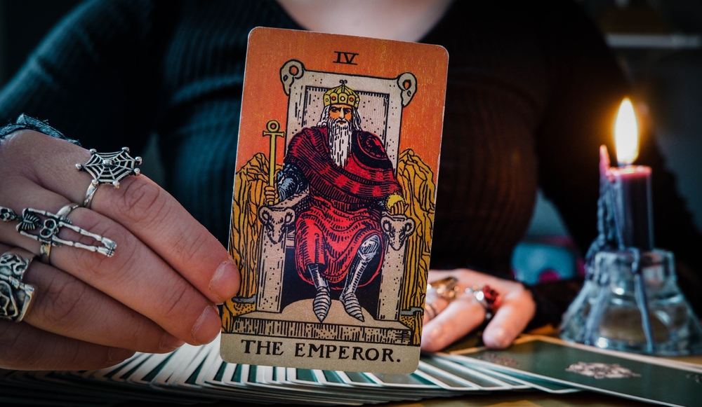 Malmö, Sweden - April 1, 2024: Emperor Major Arcana Tarot Card Rider Waite Smith. Spiritual altar, Divination tool, witchcraft, healing crystals, fortune telling cards, cartomancy.