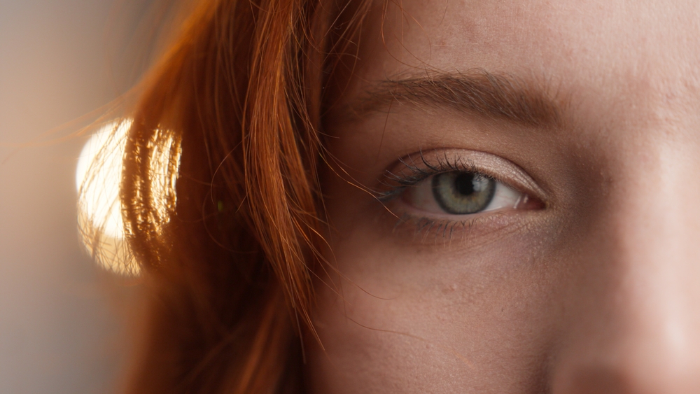 Redhead Caucasian woman girl open eyelid looking at camera green eye beautiful female lady face close up detail blink model beauty emotion ophthalmology healthy eyesight good vision home eyeball stare