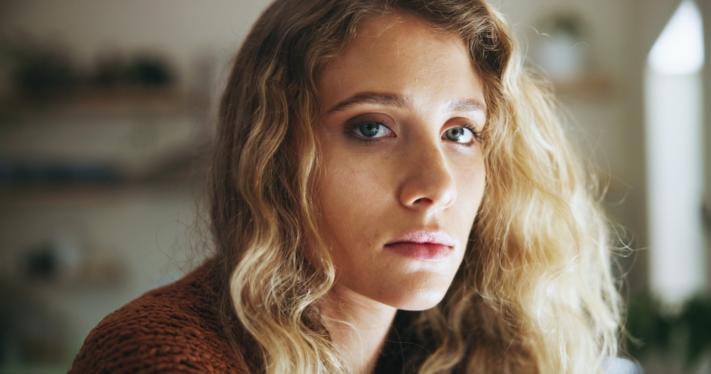 Sad, woman and portrait with depression in home for flashback, grief and burnout in dissociation. Mental health, lonely and face of person with fatigue of psychological trauma, ptsd and anxiety