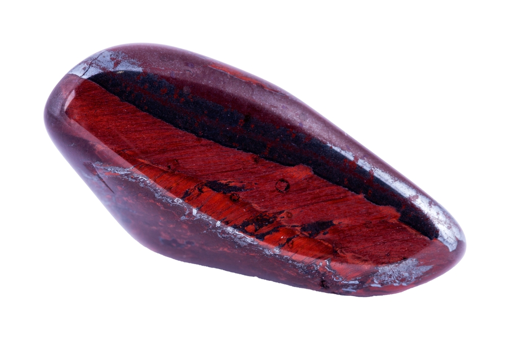 Bull eye mineral stone, tiger's eye in the breed on a white background close up