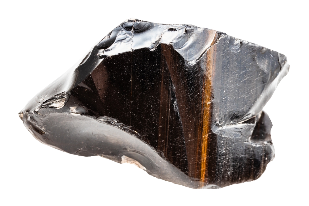 close up of sample of natural stone from geological collection - striped raw obsidian volcanic glass from Armenia isolated on white background