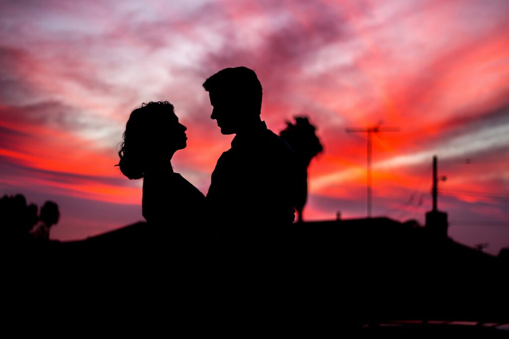 silhouette of man and woman facing each other during golden hour
