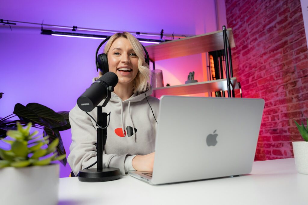 a woman sitting in front of a laptop computer
