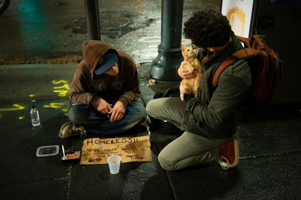 two men sitting on road
