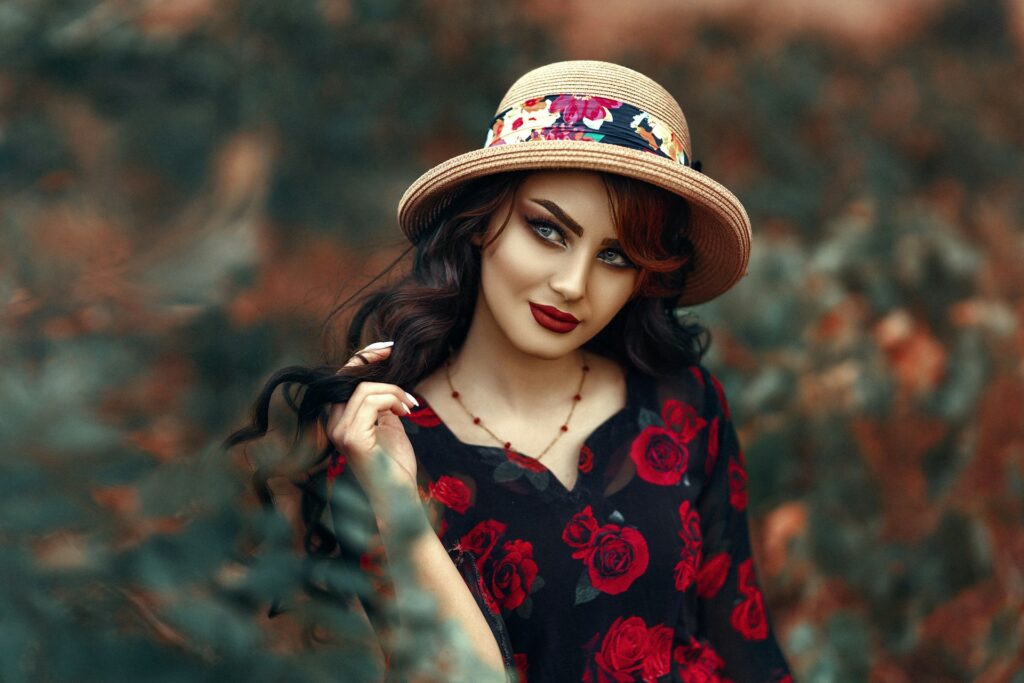 a woman in a hat poses for a picture
