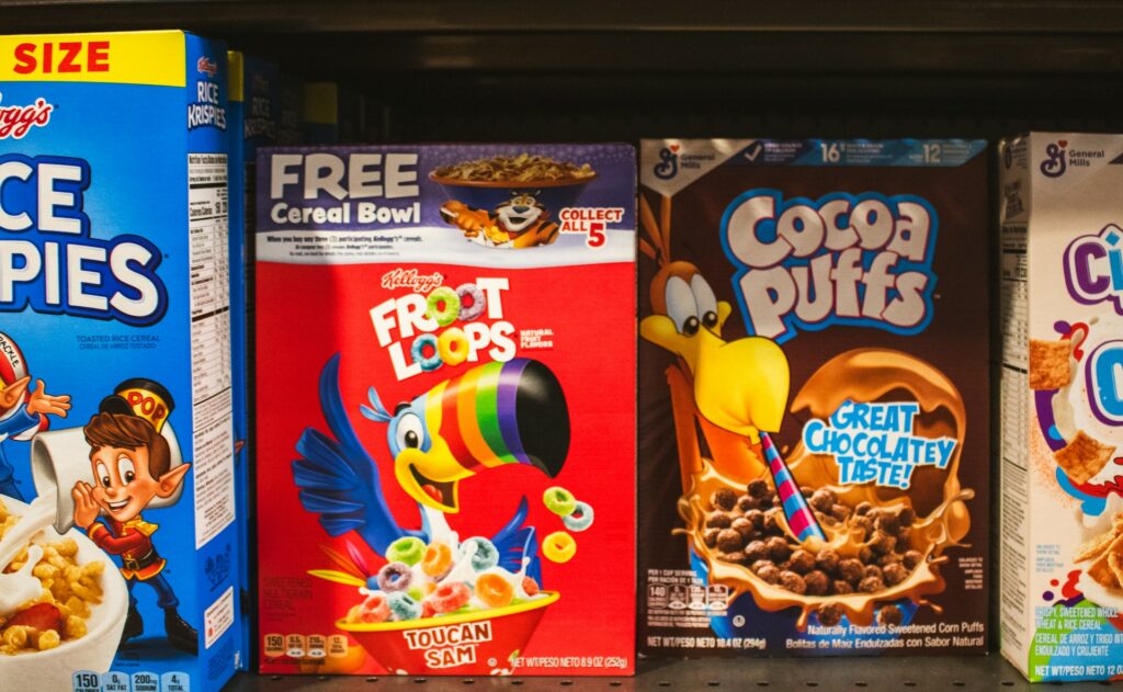 Cereal boxes displayed on a supermarket shelf.
