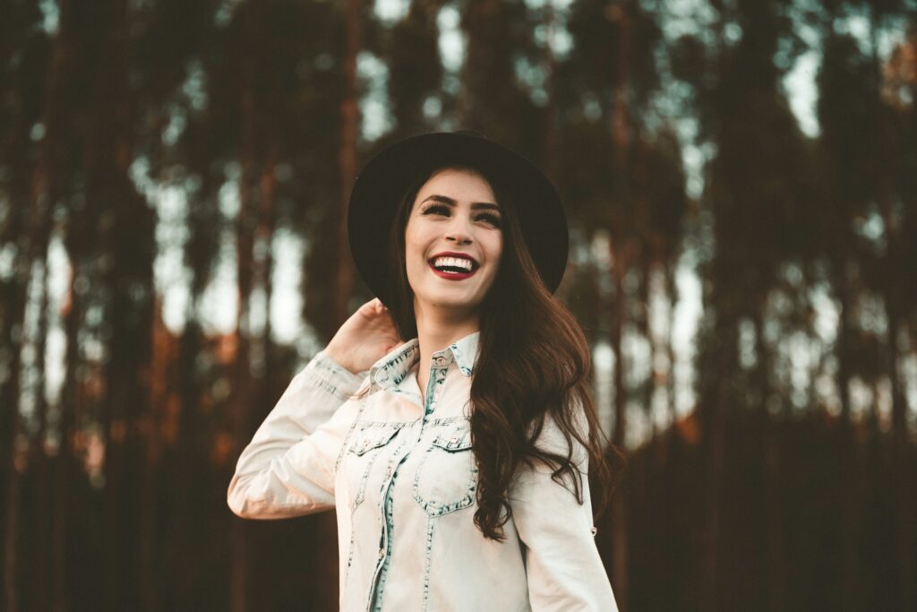 Woman in hat with tall trees