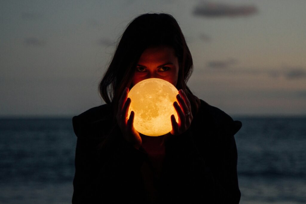 woman holding moon lamp
