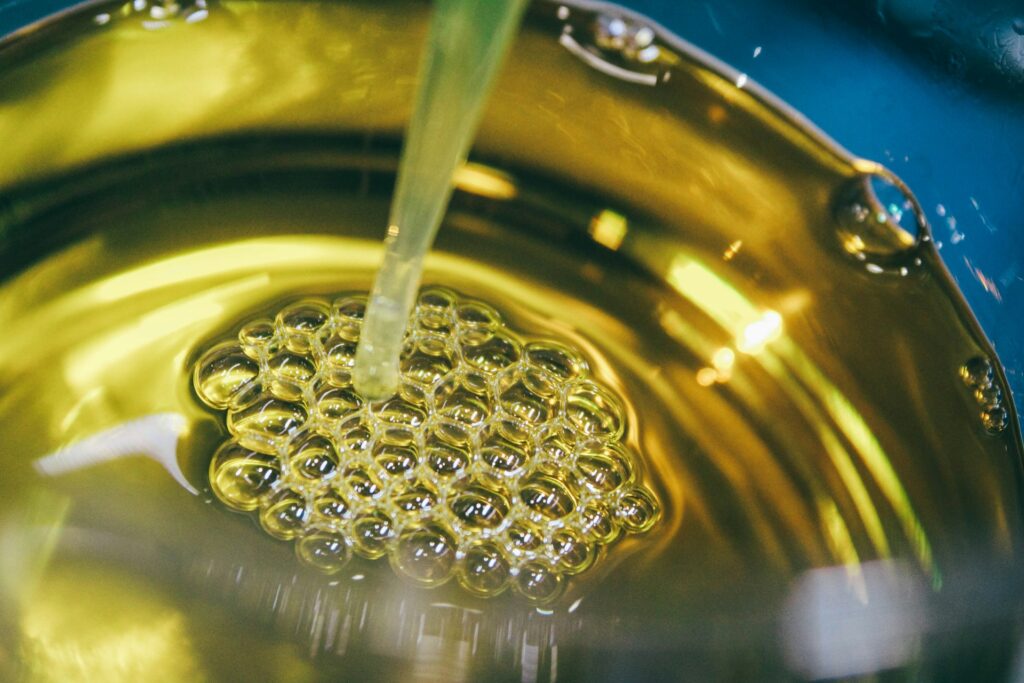 a metal bowl filled with yellow liquid