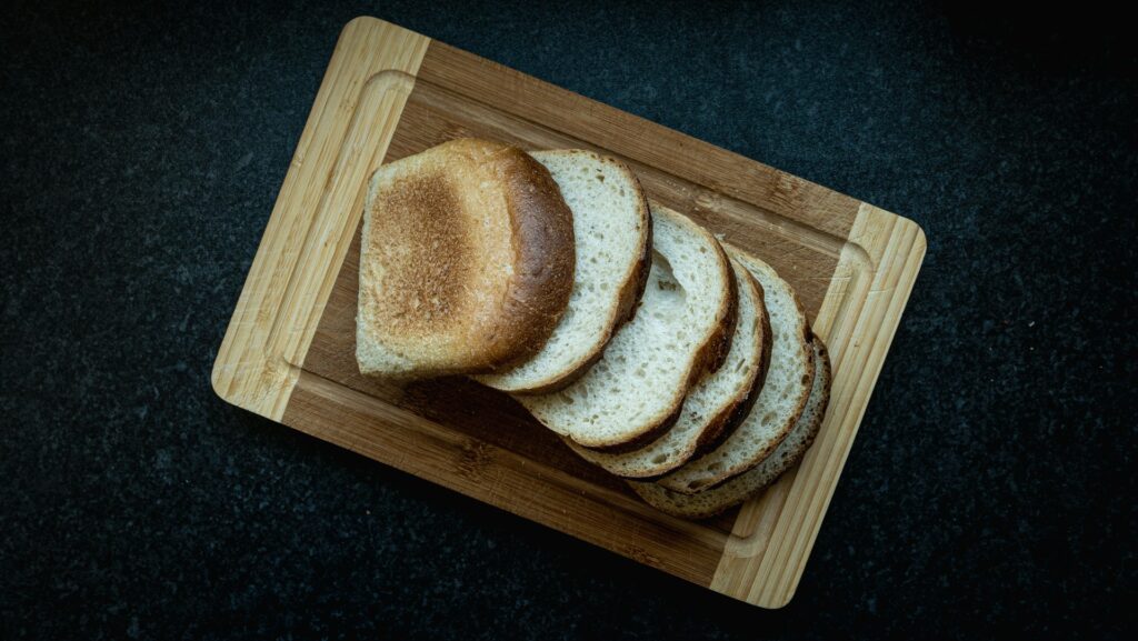 a piece of bread on a wooden cutting board