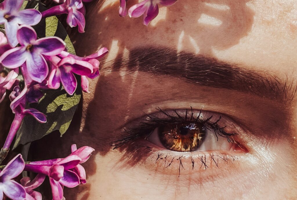 A close up of a person with flowers in their hair