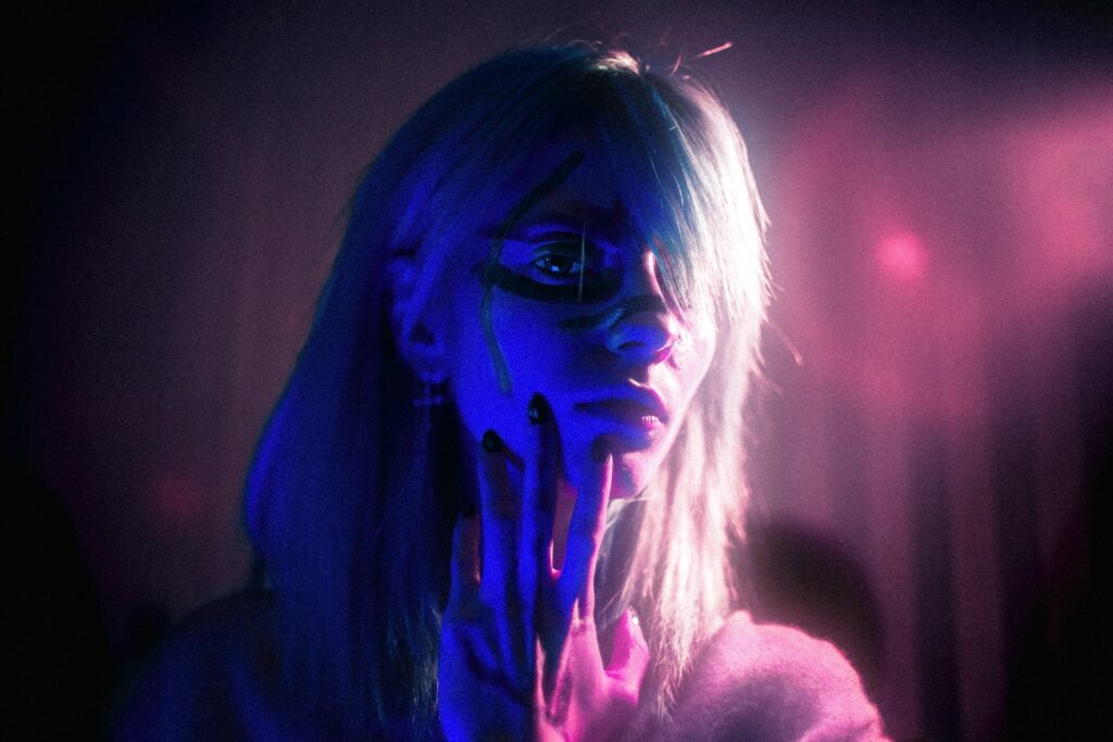 woman with purple hair and black eyes
