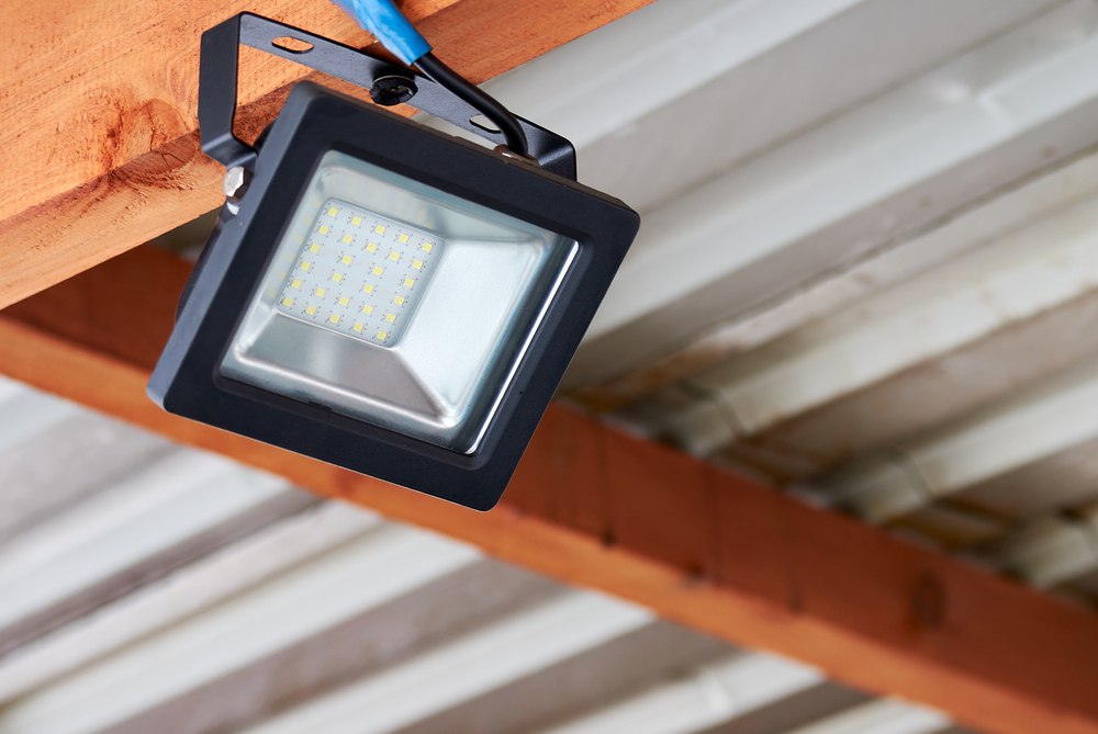 LED flood light, spot light on the top of the roof. Powerful construction lighting floodlight a lantern for illumination of a local area at night