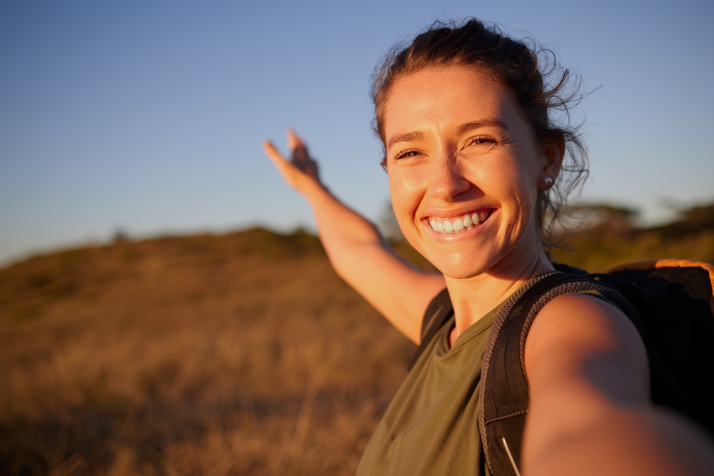 I want to share my journey with everyone. Shot of a young woman taking a selfie while out hiking.