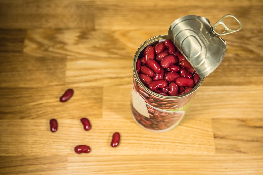a can of canned red beans on a wooden kitchen counter