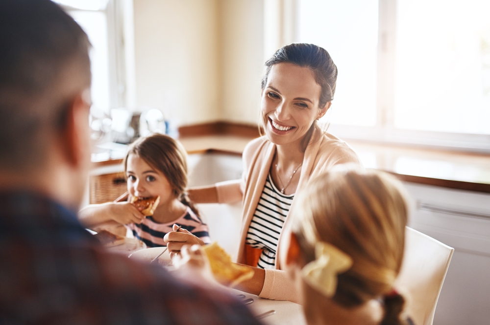 Woman, family and eating breakfast kitchen for bonding, love and care or healthy nutrition in morning of kid development. Parents, children and diet food, meal and lunch wellness growth at house