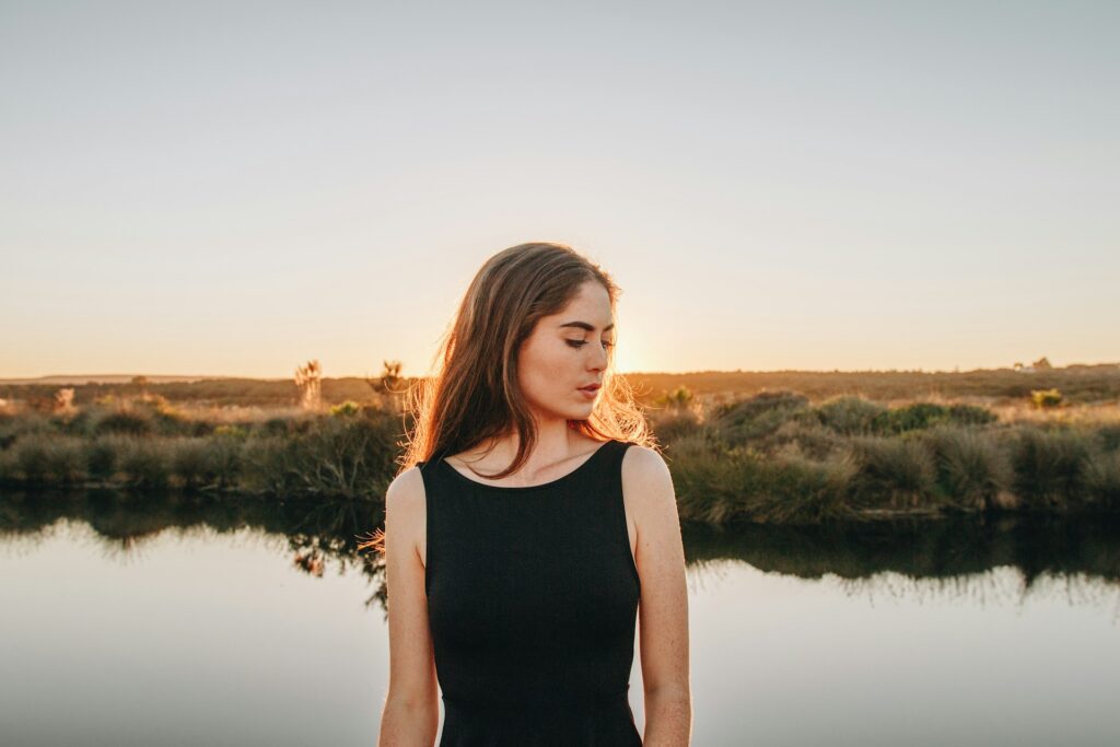 woman standing near pond
