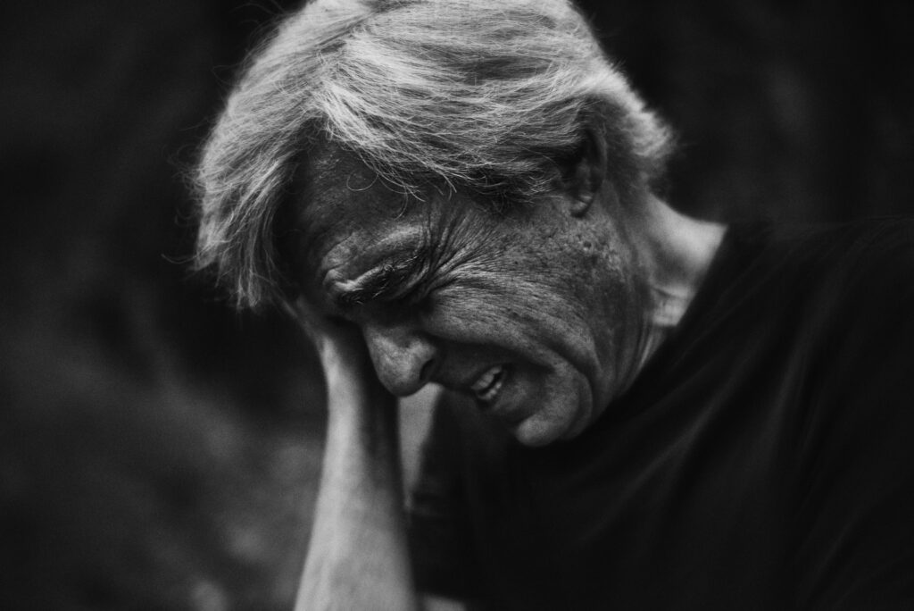 Man with face in hands.