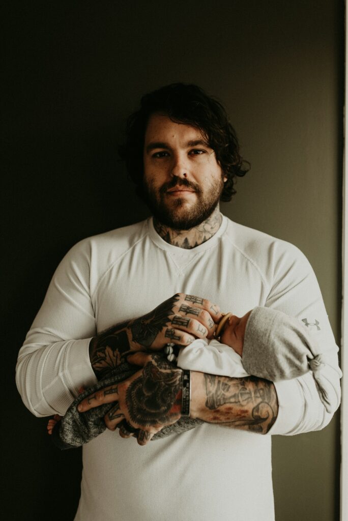 man in white crew neck t-shirt with tattoo on arm
