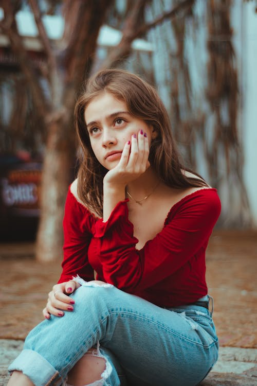 Woman with Brown Hair Sitting and Posing
