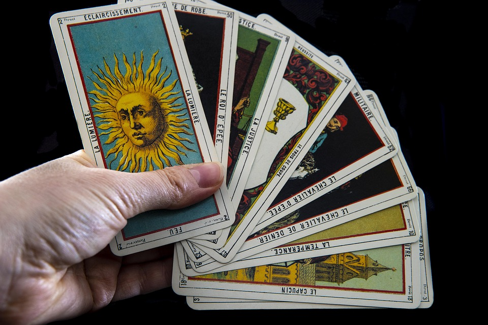 A set of tarot cards being held
