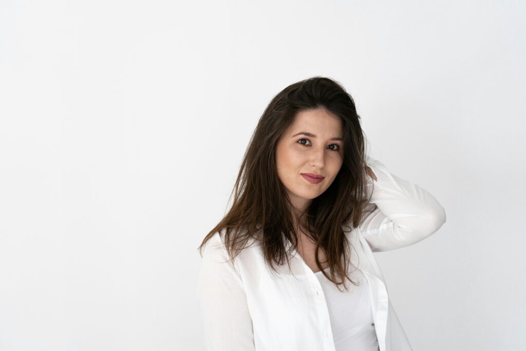 Woman in white against white wall