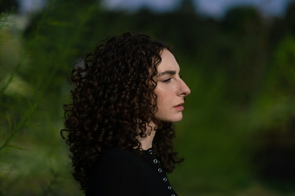 a close up of a person with curly hair