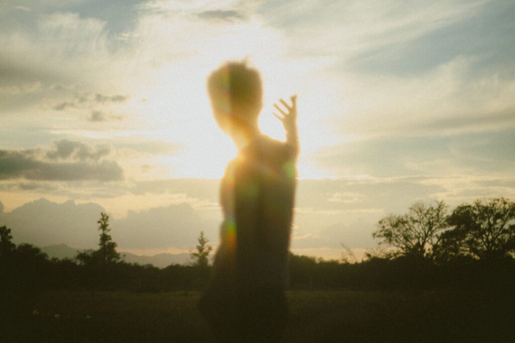 Blurred Silhouette of a Man with an Arm Raised
