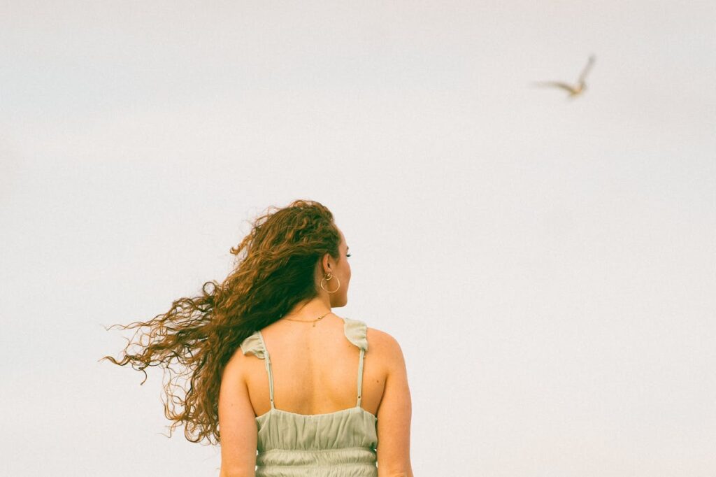 Woman with Curly Hair Gazing at Sky