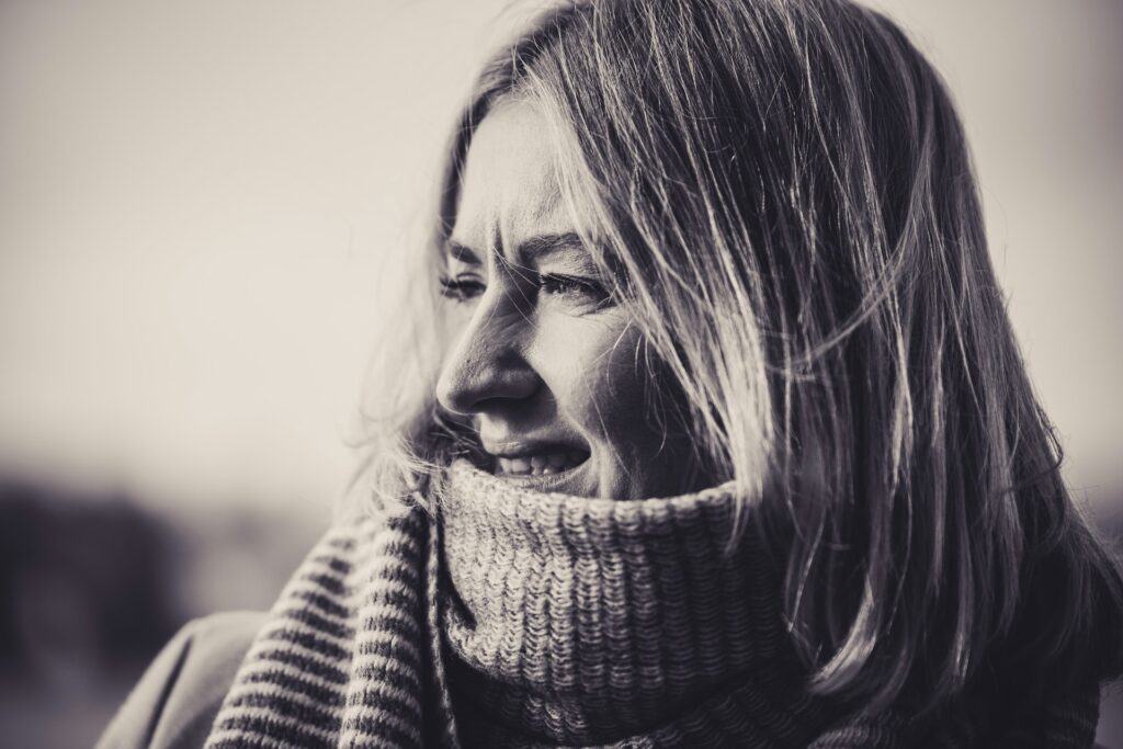 A black and white photo of a woman wearing a scarf