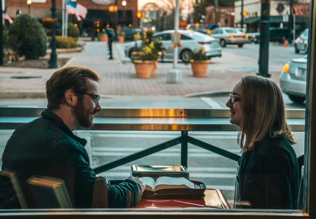 man-and-woman-sitting-while-talking-during-daytime