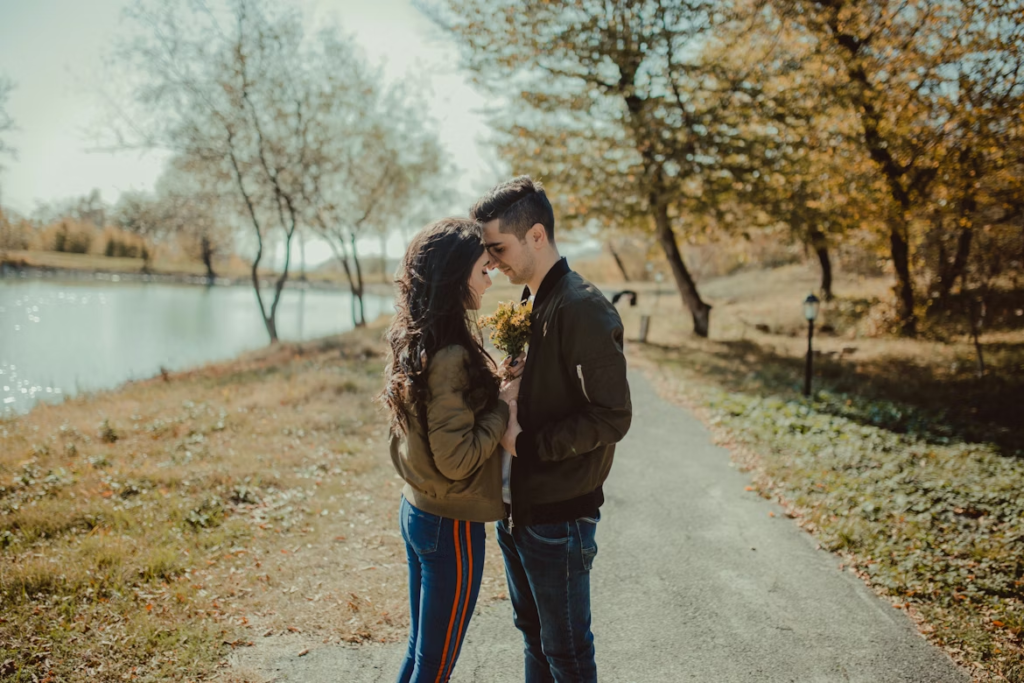 man-and-woman-facing-each-other-standing-on-footpath-beside-body-of-water