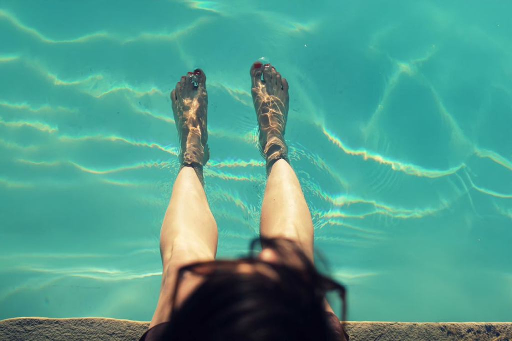 Relaxing Feet Dipped in Refreshing Pool Water
