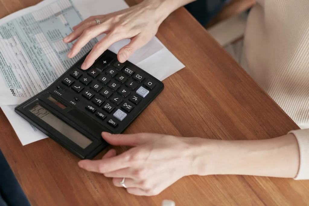 woman using calculator paying bills