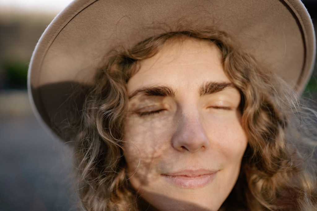 A Close-up Shot of a Woman Smiling with Her Eyes Closed