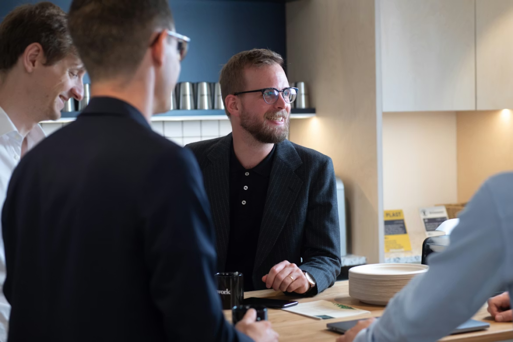 a-group-of-men-standing-around-a-kitchen-counter
