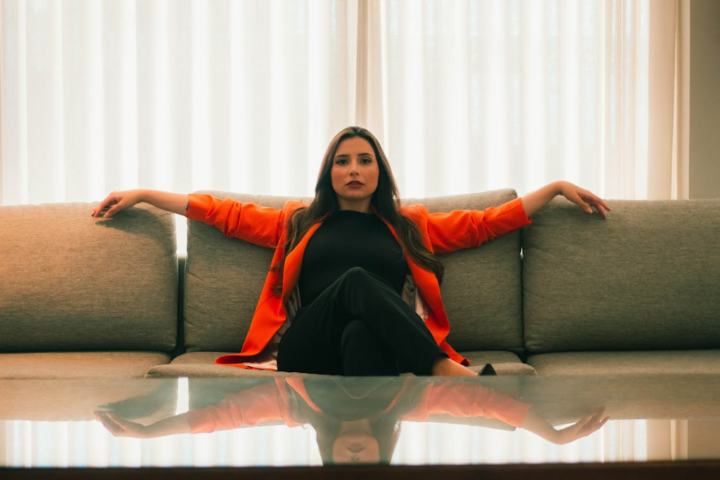 Young Elegant Woman Sitting on a Sofa