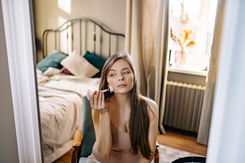Woman applying make-up in the mirror