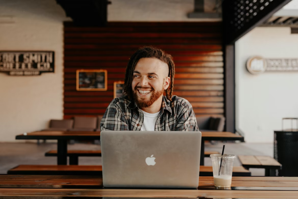 man-in-black-and-white-plaid-dress-shirt-using-silver-macbook