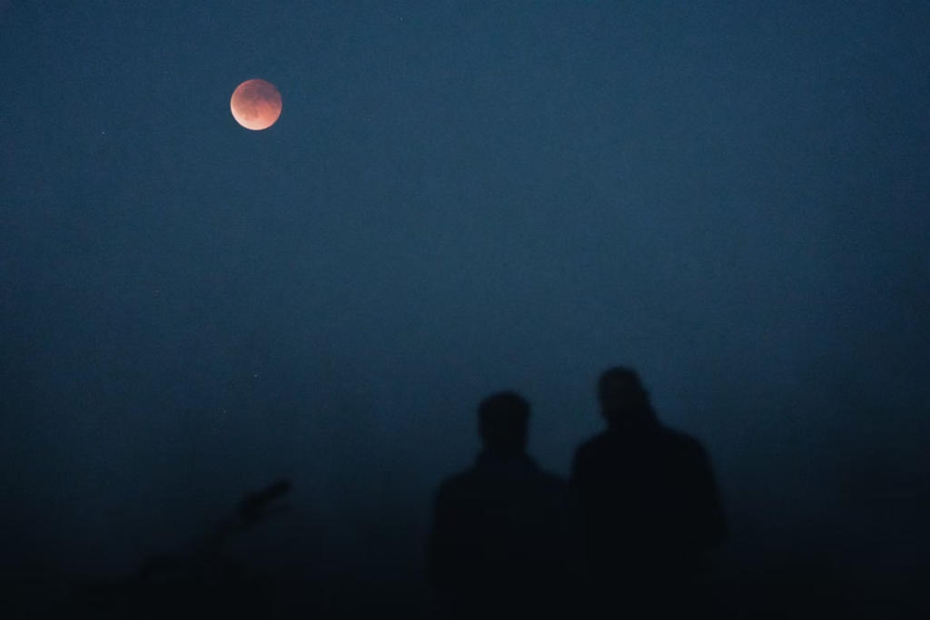 two people staring at the moon