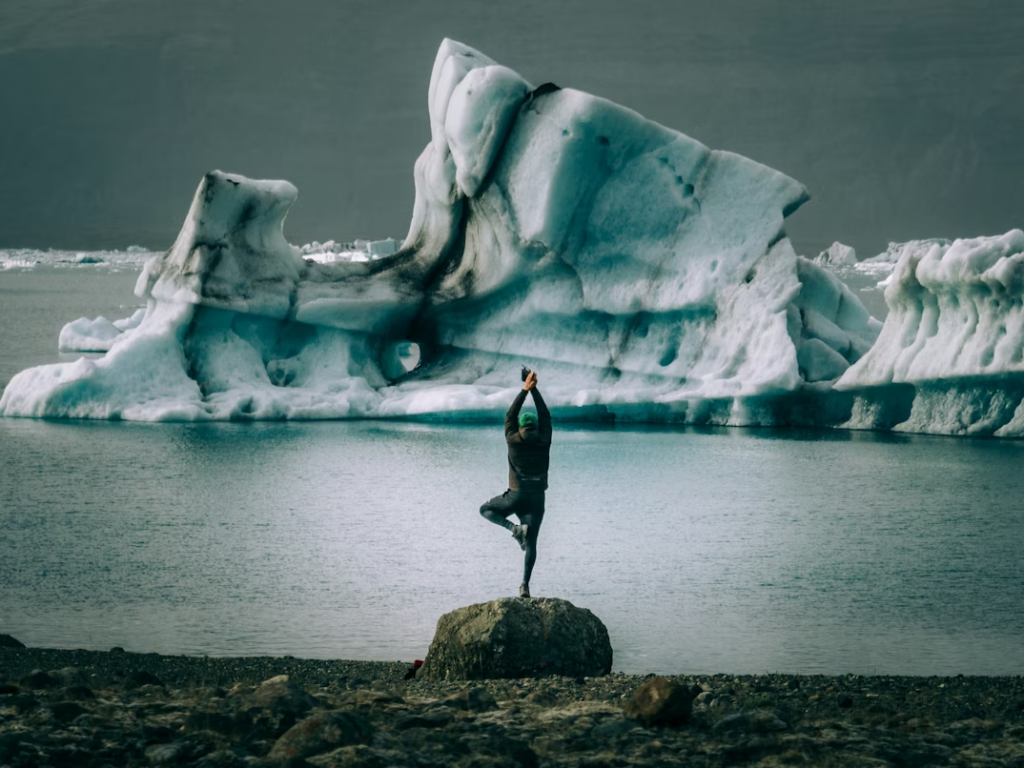 image of-person-standing-on-a-rock-in-front-of-an-iceberg
