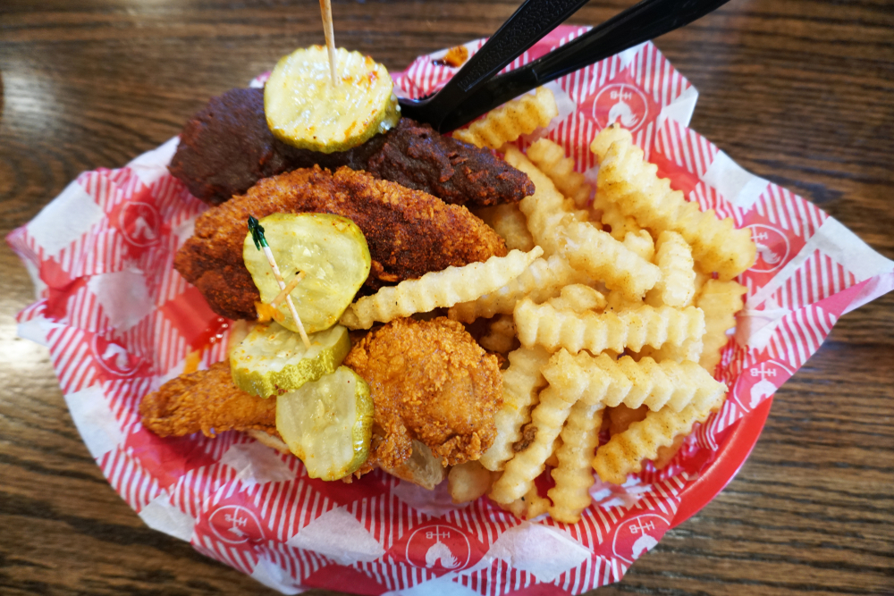 Nashville, Tennessee / USA - 07/20/2019: Extremely Hot Chicken Tenders and Fries meal at the Famous Hattie B's Hot Chicken Restaurant.
