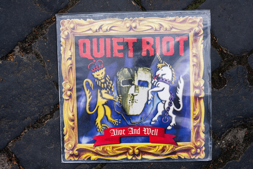 Lviv, Ukraine - May 13, 2025: The Quiet Riot Alive and Well album 1999 cover featuring bold visuals and medieval themes.
