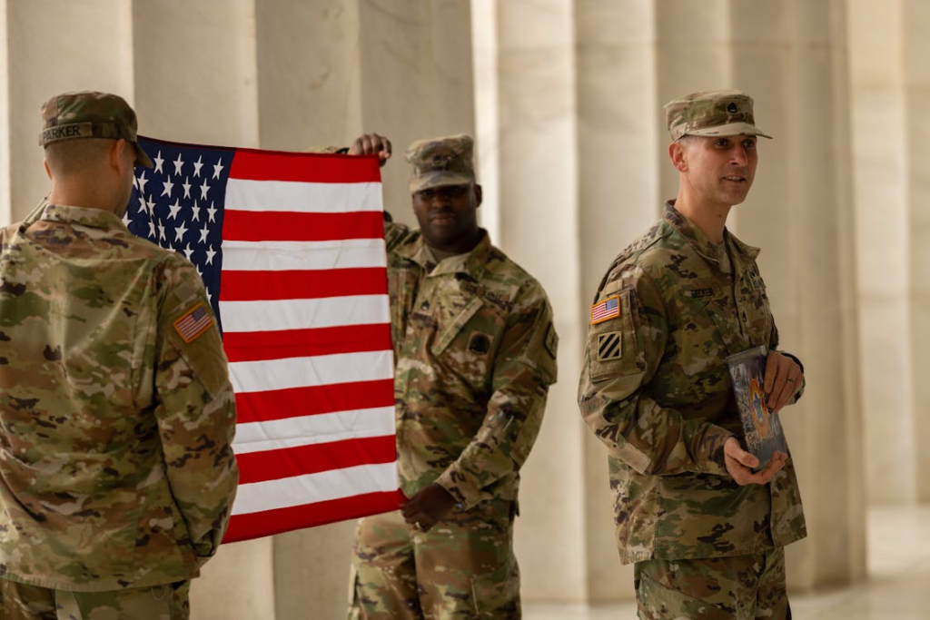 Soldiers in Uniforms Holding the American Flag
